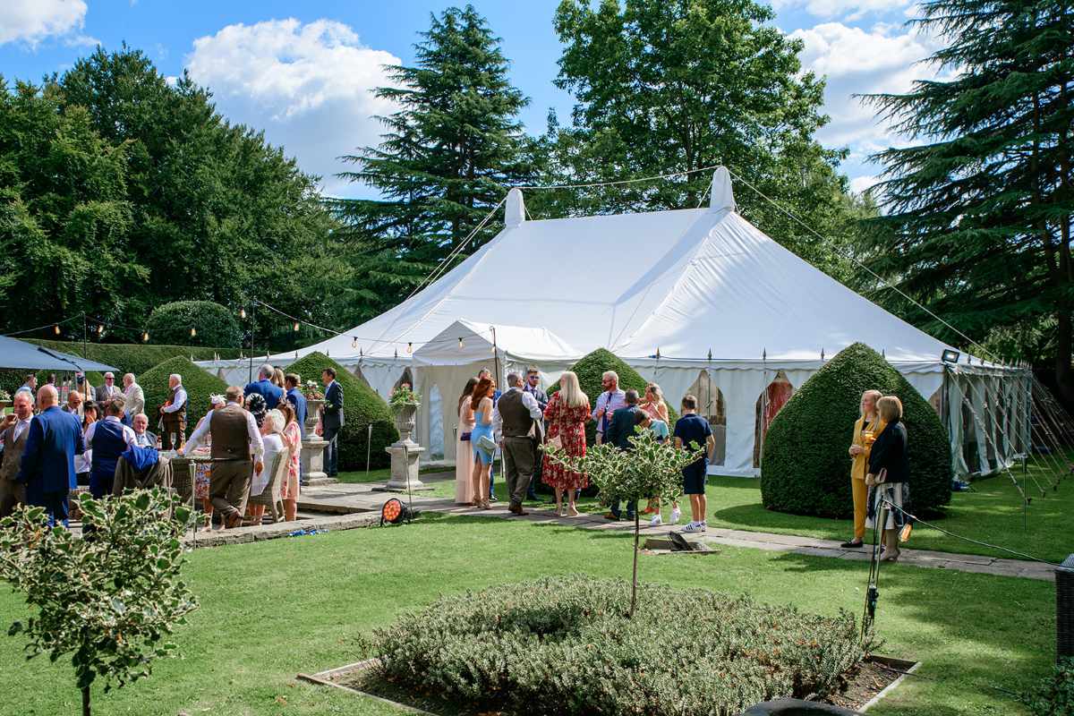 guests enjoy a summer garden marquee wedding